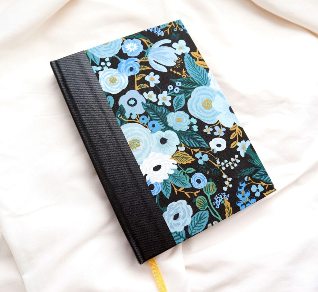 case binding with black buckram spine blue and black flowers fabric covers