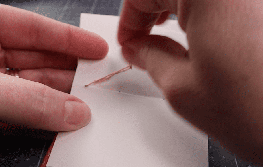 attaching the last signature to the back cover of a coptic binding step by step