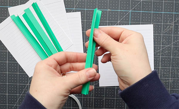 wrap a single sheet of paper within a fold to provide a base for sewing single sheets