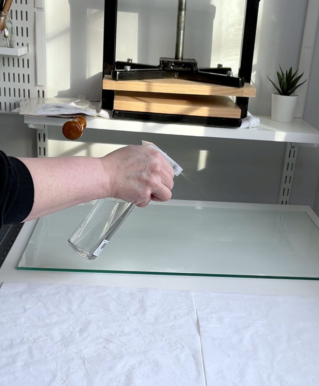 making book cloth spray glass sheet to prep for cloth