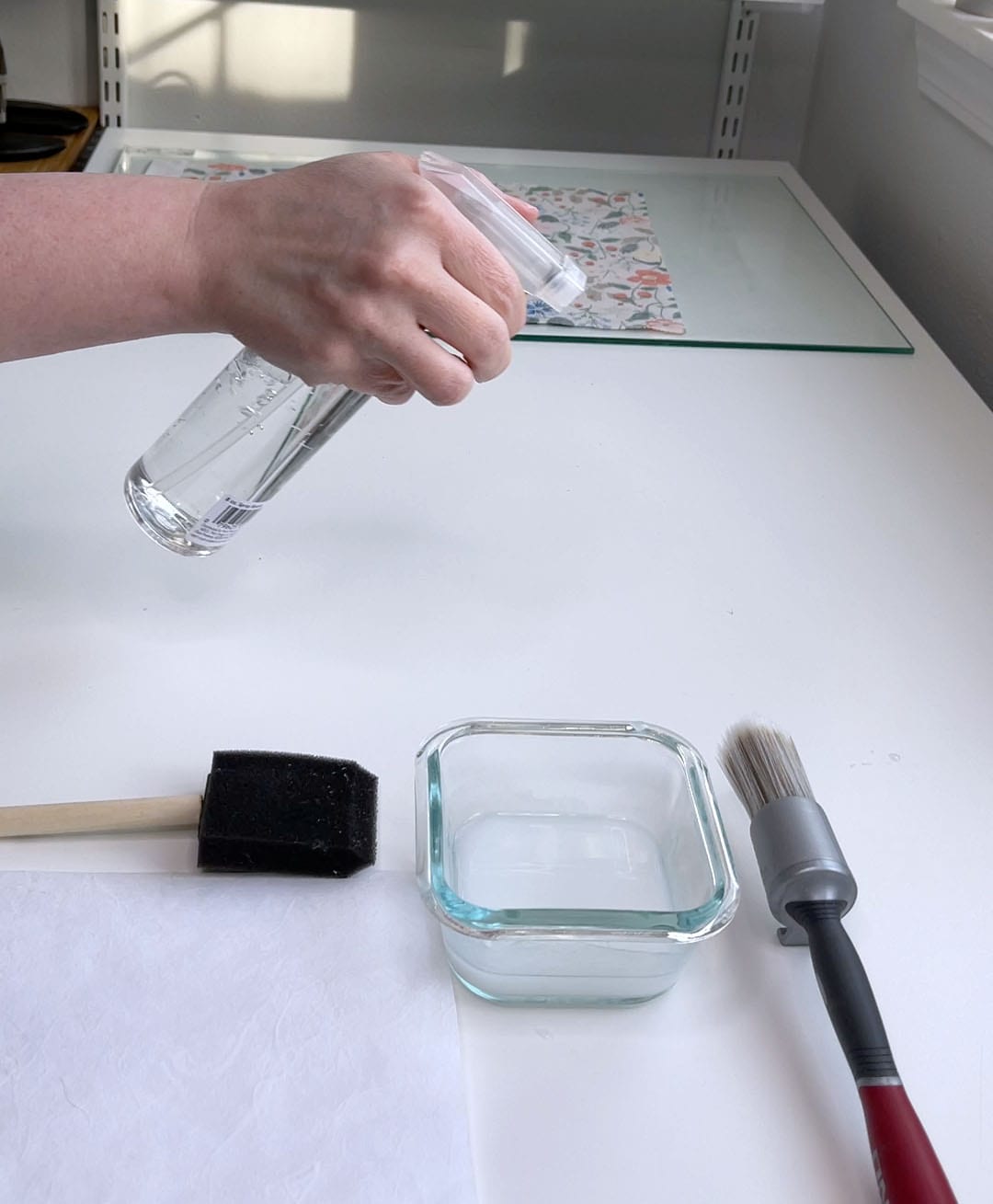 spray the table next to the glass sheet