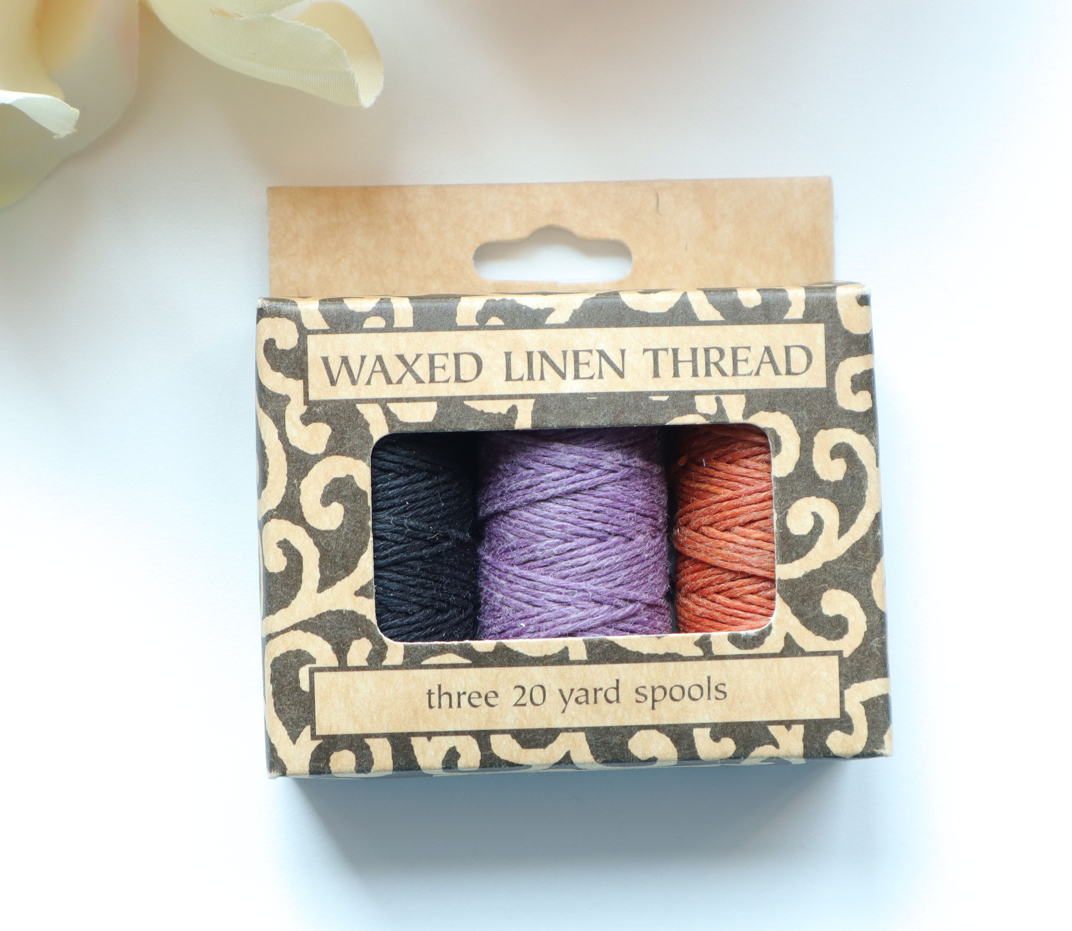 lineco 5 ply waxed linen thread in box with black purple and burnt orange colors