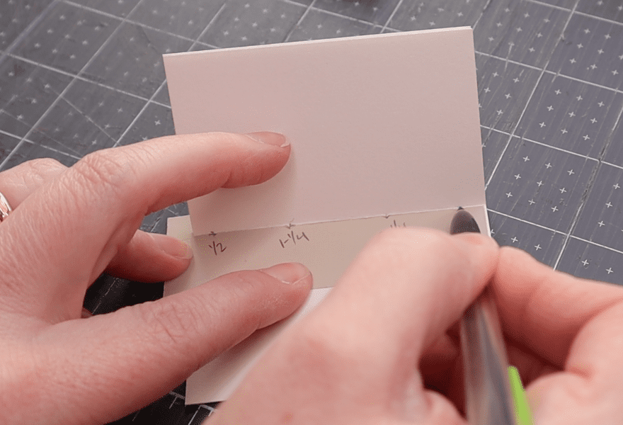 using a template and pencil to mark piercing stations on the crease of a folded signature
