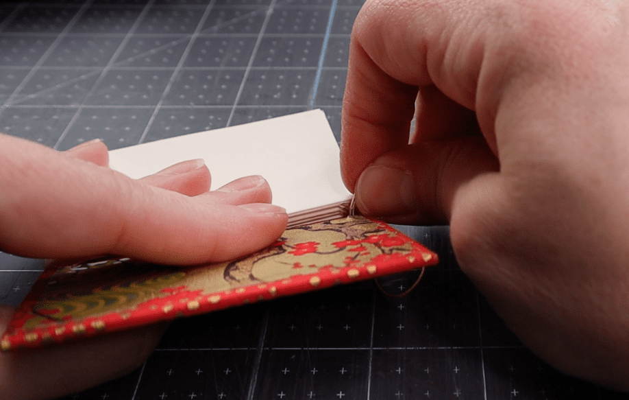 steps showing how to attach the last board and final signature of a coptic binding