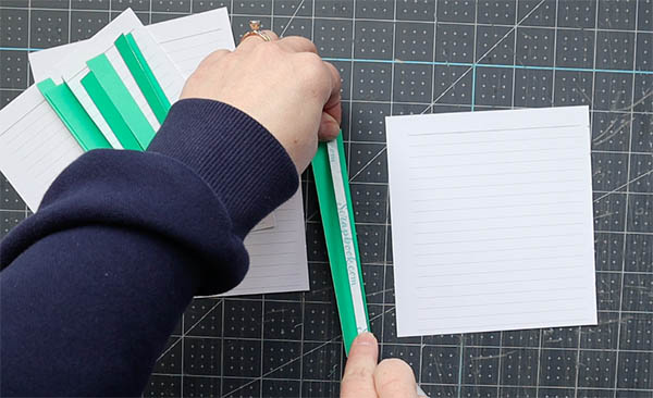 wrap a single sheet of paper within a fold to provide a base for sewing single sheets