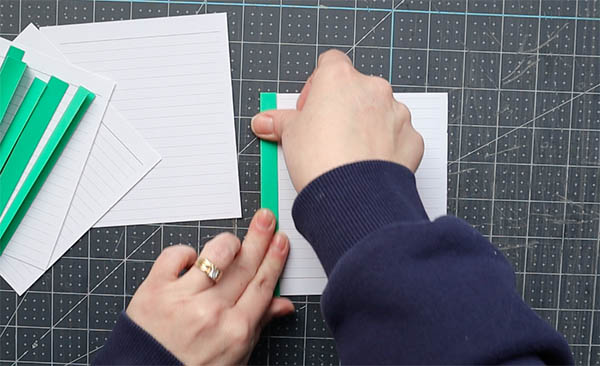 wrap a single sheet of paper within a fold to provide a base for sewing