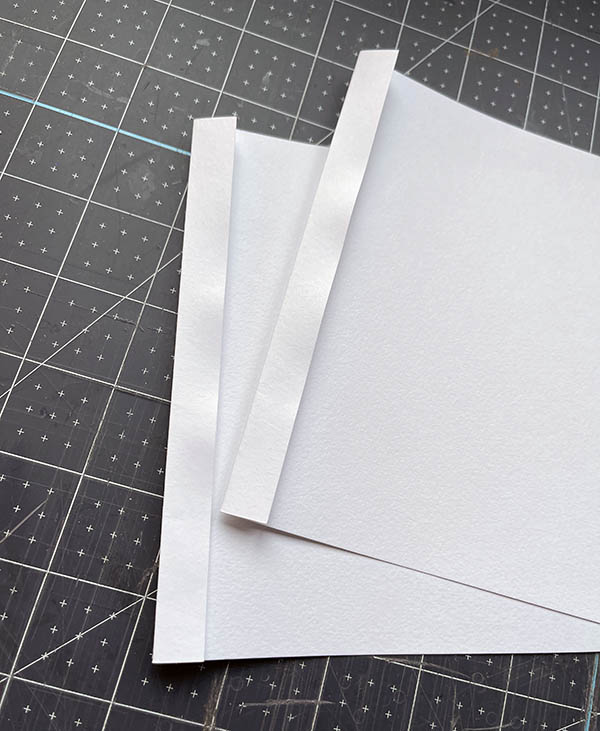fold over one end of a single sheet of paper to create a fold through which to sew
