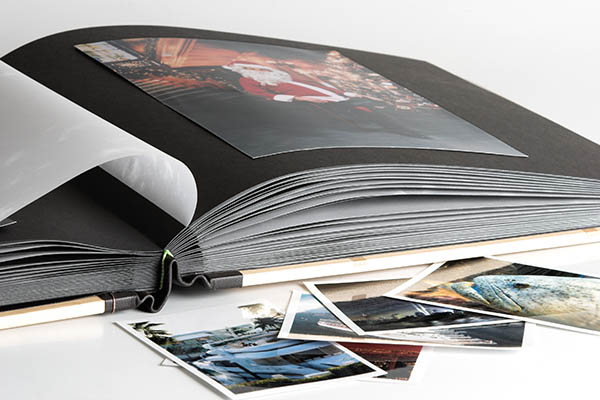 handmade photo album binding featuring interleaves of glassine sheets and casebound method