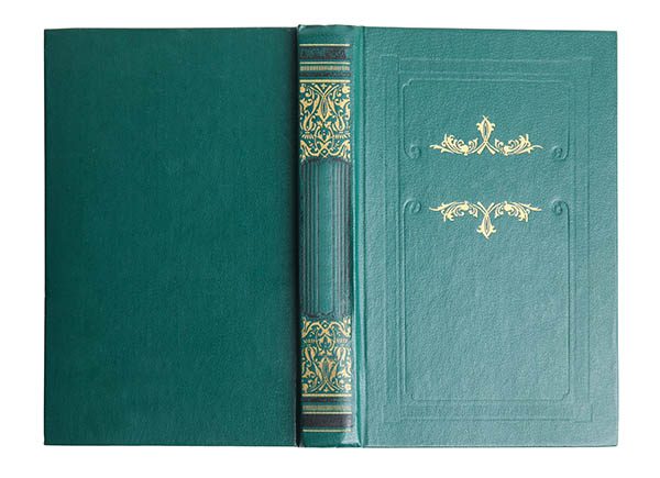 Open old book with vintage green cover and gold stamping isolated on white, top vi