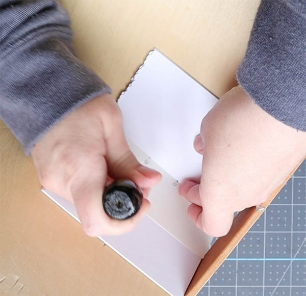 use a punch cradle to make piercing signatures much easier in bookbinding