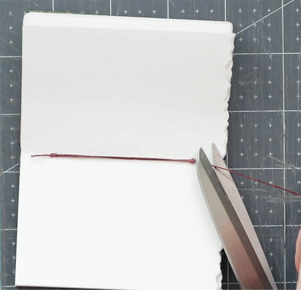 attach the last board of the two needle coptic binding journal bookbinding tutorial