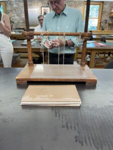 sewing a book on a wooden frame