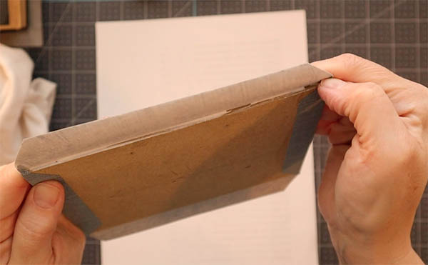 press the edge with your thumb nails to help create two corners