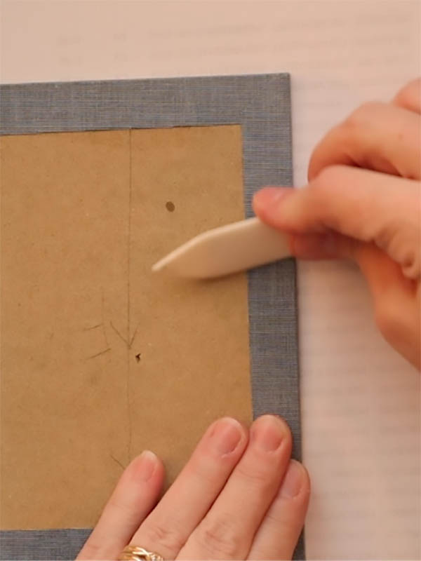 turn the fore edge flap over and press with your fingers or a bone folder to remove bubbles