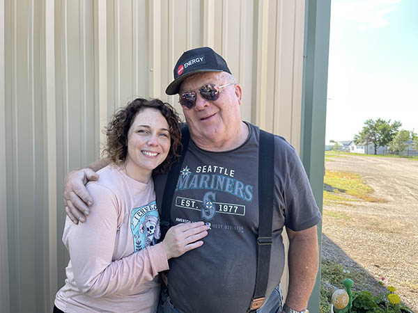 a photo of my dad and i standing in front of his garage