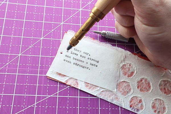 punch a hole in the weathergram layers using a japanese screw punch, awl or other pointy device