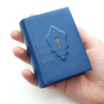 🐛 Okay everybody, here's my finished mini Alice in Wonderland! This is the first mini I produced on my own at home and there are SO MANY learnings... where to even begin?

FIRST, I was super nervous to design anything on the leather. I'm a technical person, so the art side of it gives me anxiety. The little doors Alice has to open to chase the rabbit stuck out for me so I made a little keyhole. I don't have any tooling stuff, so I just used thinly pared leather in a gold color to fill it in. I think it turned out okay, but I can't wait to learn tooling on my own. (PSA - tooling is expensive to get into 😬)

SECOND, I need different tapes... mine didn't fray well and left raised marks under the leather. I'm not too upset... it kinda looks cool...like little door hinges!

THIRD, creating leather caps was rough in such a small size... I need to practice, practice!!

FOURTH, feathering leather corners for such a small book was HARD. My blade felt so big on such a small piece of leather... if you have any tips, share below!

Next up: I'll print another copy of the book in a smaller size. The goal is to get this under 3 inches tall (right now, it's 3.5 inches tall). Woot!

Thanks for tuning in to see the outcome! Let me know what you think!
.
.
.
#miniaturebook #bookbindersofinstagram #bookbinding #bookarts #bookstagram #aliceinwonderland